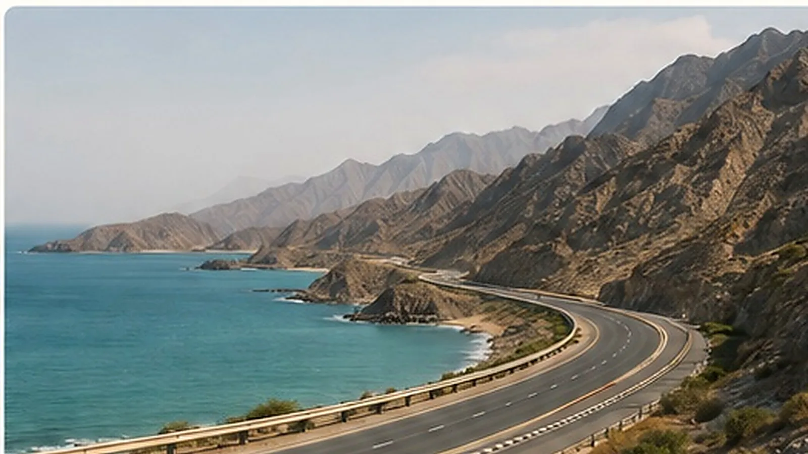 Scenic coastal mountain road leading towards Khor Fakkan